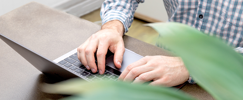 Hands typing on MacBook Air 2019